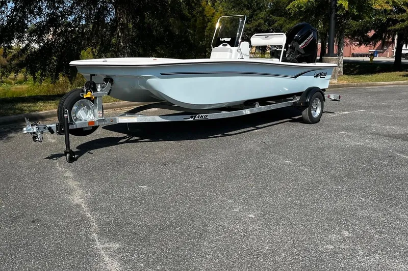 The Image of 2026 Mako Pro Skiff 17 CC boat on trailer in parking lot. - 1