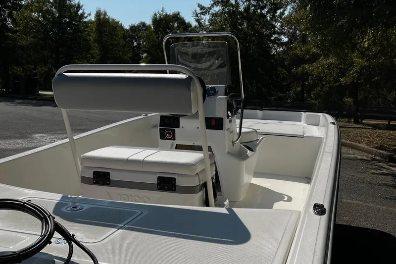 Slide: The Image of 2026 Mako Pro Skiff 17 CC boat interior with console and seating, parked outdoors. - 5