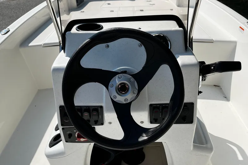 Slide: The Image of Steering console of 2026 Mako Pro Skiff 17 CC boat, featuring modern controls. - 6