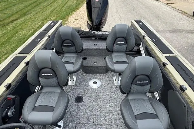 Slide: The Image of 2026 Tracker Targa V-19 Combo boat interior with four gray seats, carpeted floor, and steering console. - 3
