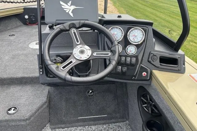 Slide: The Image of 2026 Tracker Targa V-19 Combo boat dashboard with steering wheel and gauges. - 5