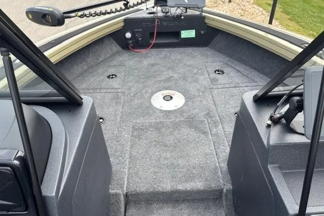 Slide: The Image of 2026 Tracker Targa V-19 Combo boat interior with carpeted deck and control panel. - 6