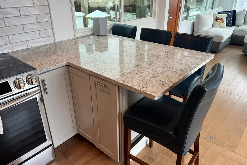 Slide: The Image of Modern kitchen interior on 1981 Sumerset houseboat with granite countertop and leather chairs. - 10