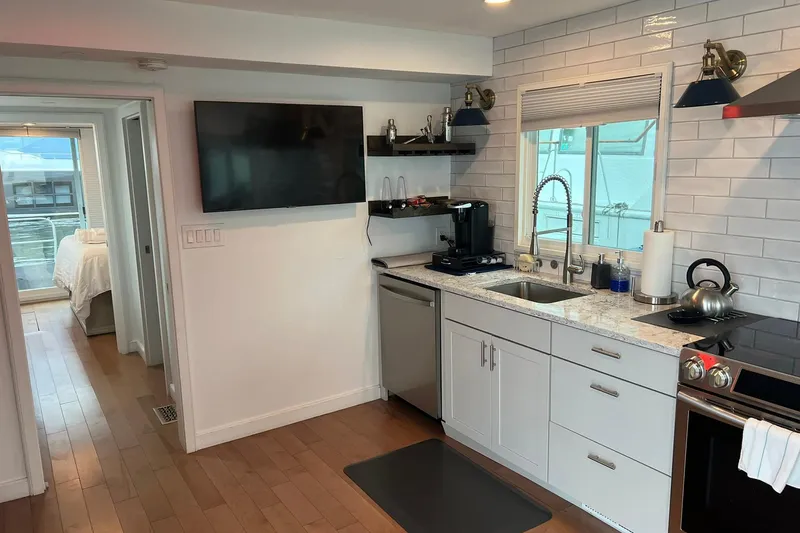 Slide: The Image of Modern kitchen interior on a 1981 Sumerset houseboat with sleek appliances and white cabinetry. - 12