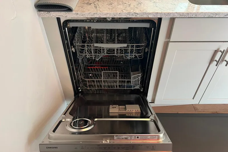 Slide: The Image of Open Samsung dishwasher in a modern kitchen on a 1981 Sumerset houseboat. - 13