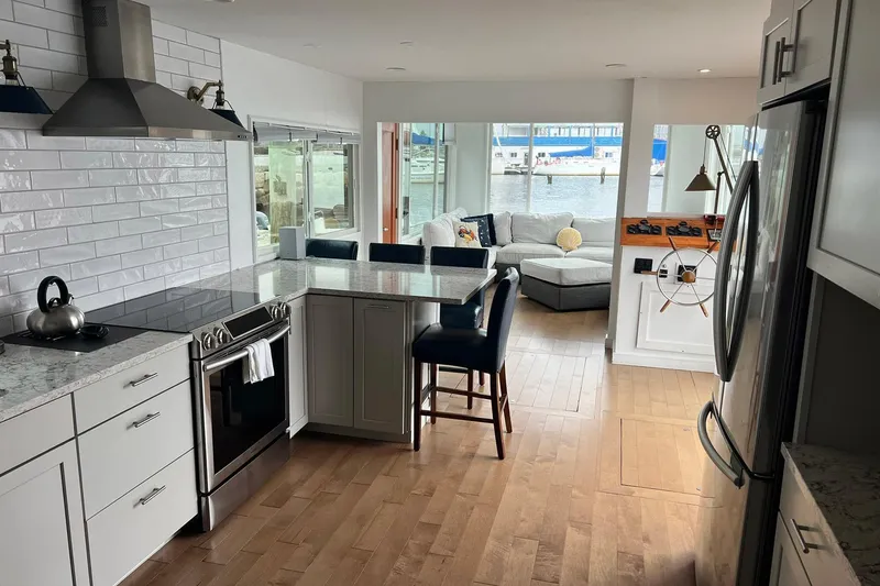 Slide: The Image of Modern kitchen and living area inside a 1981 Sumerset houseboat with waterfront views. - 14