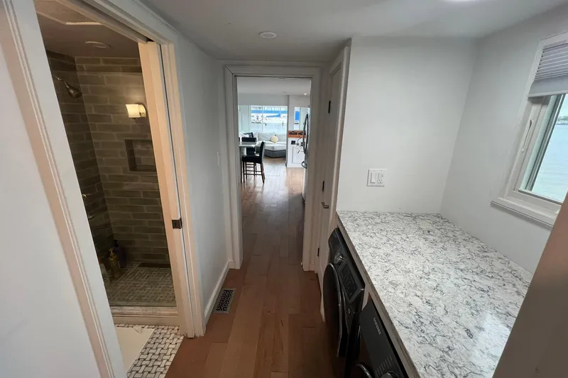 Slide: The Image of Interior of 1981 Sumerset houseboat with modern kitchen and bathroom, featuring wood flooring. - 19