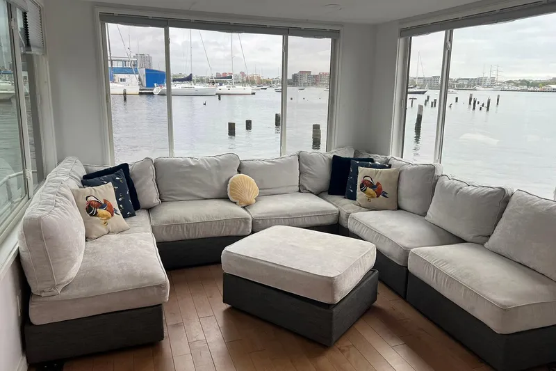 Slide: The Image of Cozy living area on 1981 Sumerset houseboat with waterfront views and plush sectional sofa. - 2