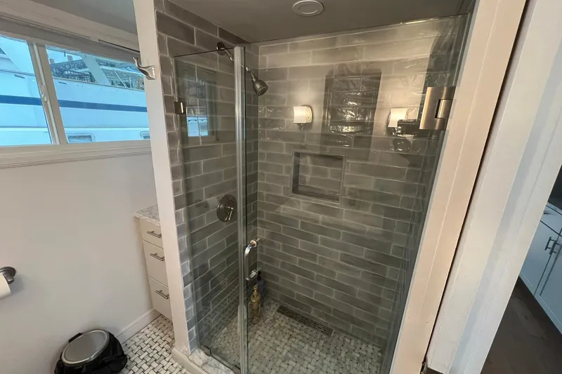 Slide: The Image of Modern shower in 1981 Sumerset houseboat with glass door and gray tile walls. - 20