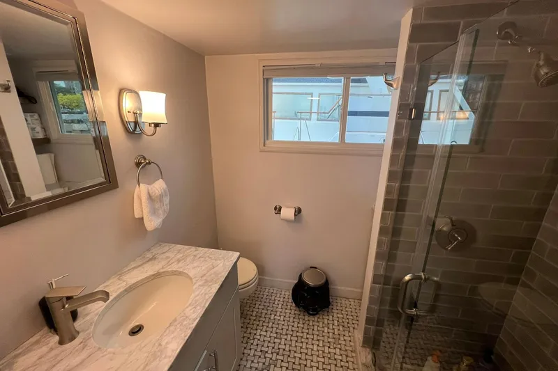 Slide: The Image of Modern bathroom in 1981 Sumerset houseboat with glass shower and marble countertop. - 22