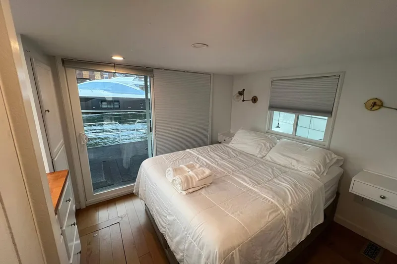 Slide: The Image of Cozy bedroom in 1981 Sumerset houseboat with white bedding and waterside view. - 24
