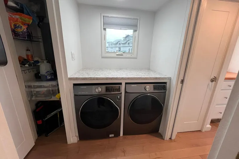 Slide: The Image of Laundry area in 1981 Sumerset houseboat with Samsung washer and dryer, storage shelves. - 26