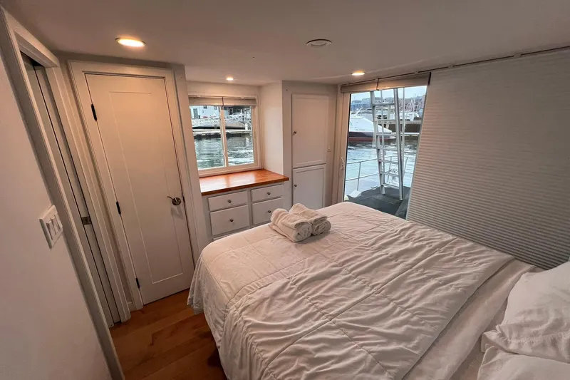 Slide: The Image of Cozy bedroom in a 1981 Sumerset houseboat with waterfront view and modern decor. - 27
