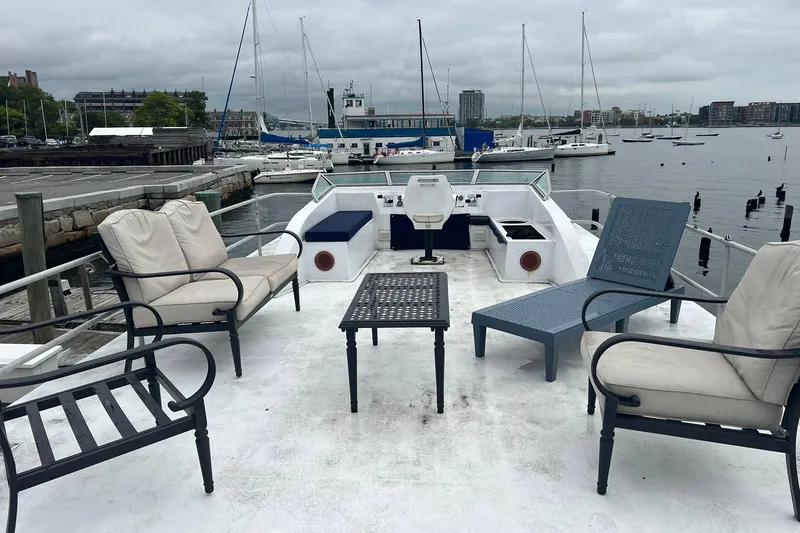 Slide: The Image of 1981 Sumerset houseboat deck with seating, table, and marina view. - 30