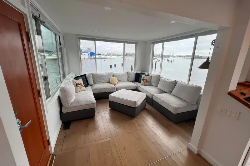 Slide: The Image of Cozy living area in 1981 Sumerset houseboat with waterfront views and plush seating. - 4