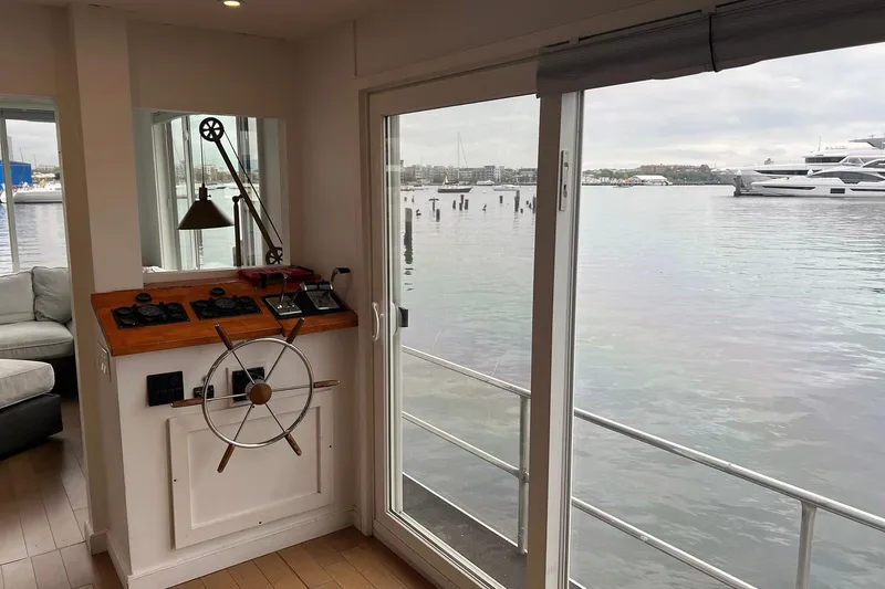 Slide: The Image of Interior view of a 1981 Sumerset houseboat with steering wheel and water view. - 6