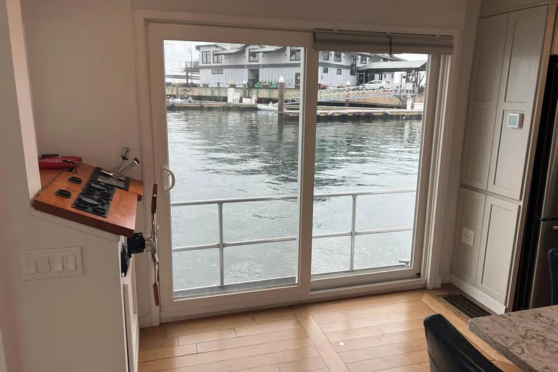 Slide: The Image of Interior view of a 1981 Sumerset houseboat with sliding glass doors overlooking water. - 7