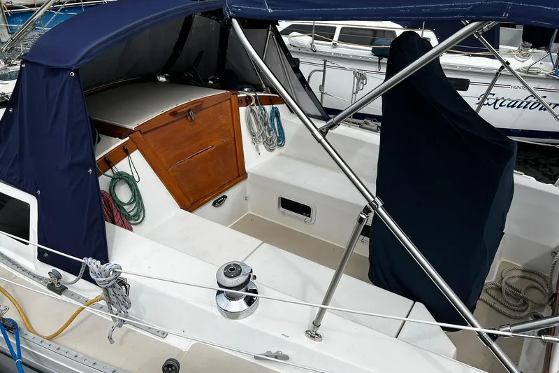 Slide: The Image of 1988 Catalina 34 sailboat cockpit with blue canopy and wooden hatch. - 11