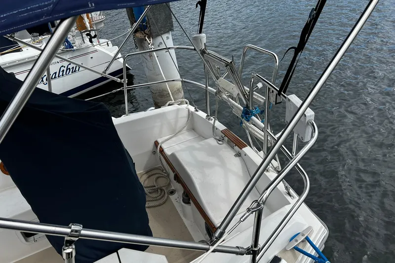 Slide: The Image of 1988 Catalina 34 sailboat cockpit with stainless steel railings and covered seating. - 12