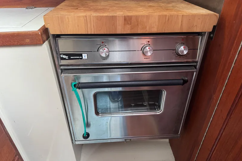 Slide: The Image of Stainless steel oven in 1988 Catalina 34 yacht kitchen with wooden countertop. - 14