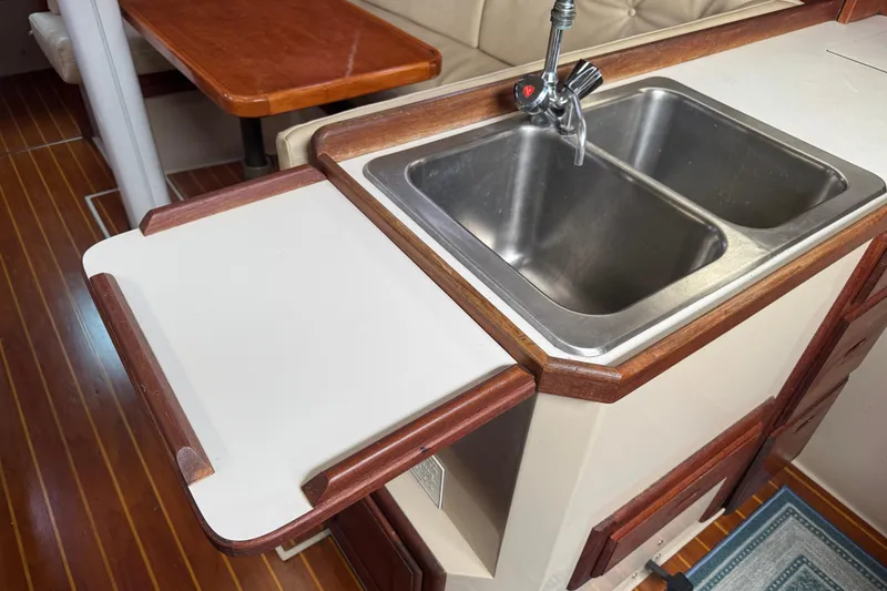 Slide: The Image of 1988 Catalina 34 yacht interior with double sink and wooden countertop. - 17