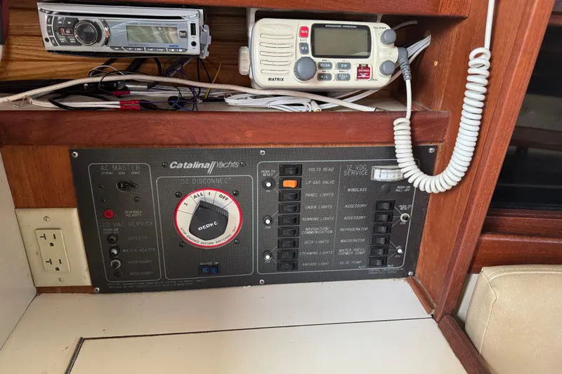 Slide: The Image of Control panel of a 1988 Catalina 34 yacht with radio and electrical switches. - 21