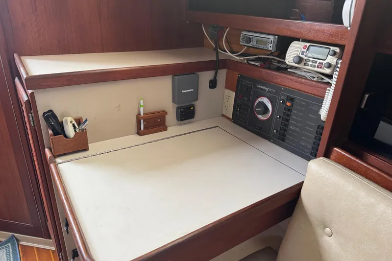 Slide: The Image of Navigation station inside a 1988 Catalina 34 sailboat with communication equipment. - 22