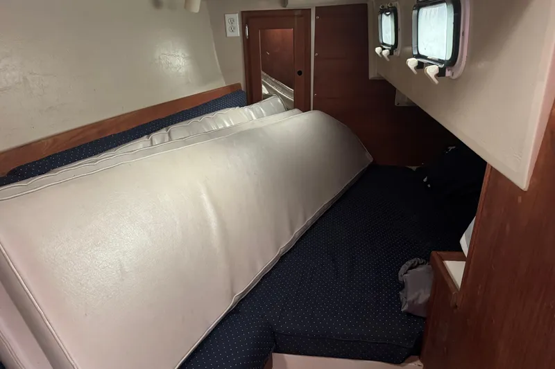 Slide: The Image of Interior cabin of a 1988 Catalina 34 sailboat with cushions and portholes. - 25