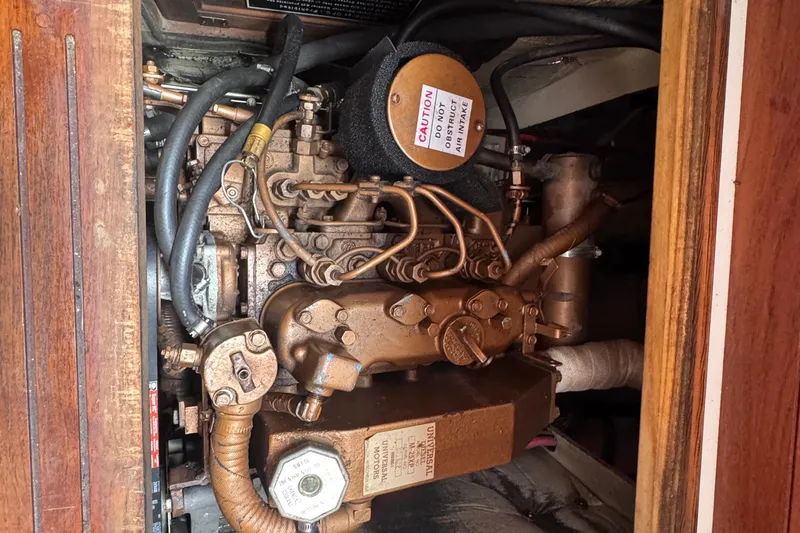 Slide: The Image of Engine compartment of a 1988 Catalina 34 sailboat, showing detailed mechanical components. - 33