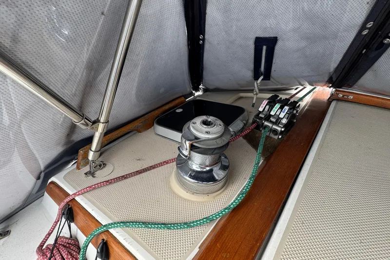 Slide: The Image of 1988 Catalina 34 sailboat deck with winch, ropes, and hardware. - 46