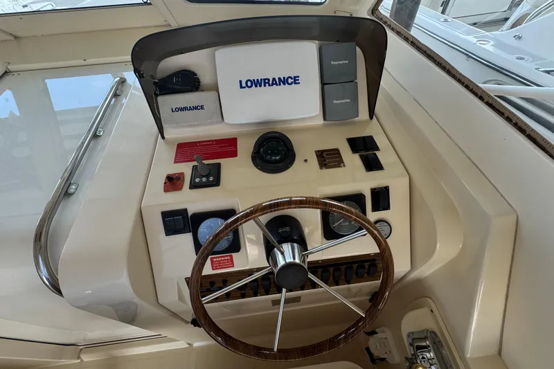 Slide: The Image of 2003 Mainship Pilot 34 helm with Lowrance and Raymarine navigation equipment. - 11