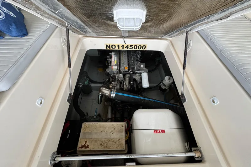 Slide: The Image of Engine compartment of a 2003 Mainship Pilot 34 boat, showcasing mechanical components. - 32
