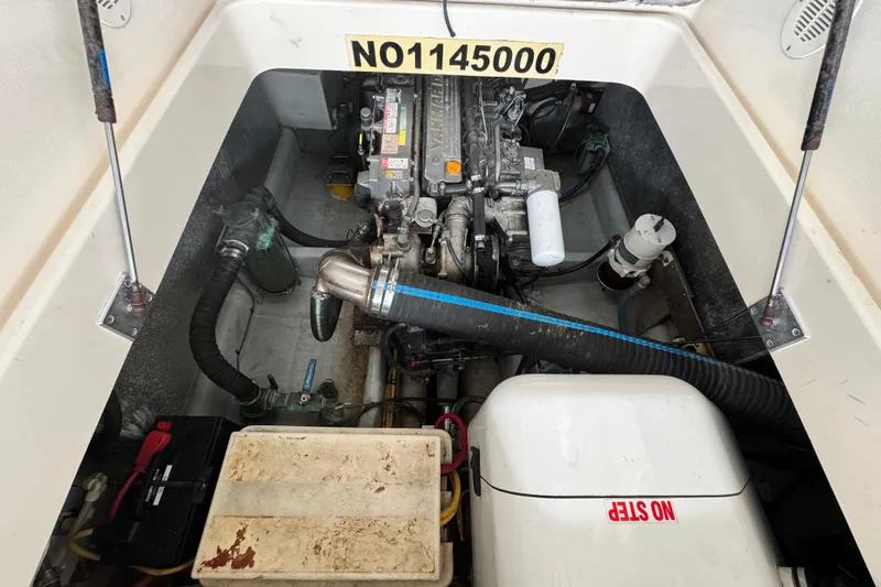 Slide: The Image of Engine compartment of a 2003 Mainship Pilot 34 boat, showing mechanical components. - 33