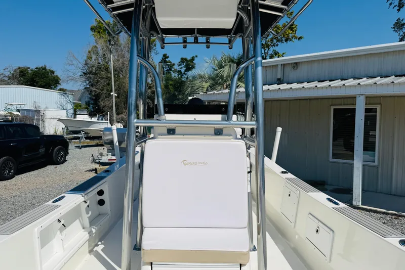 Slide: The Image of 2023 Banks Panga 23 Center Console boat with T-top and seating, parked outdoors. - 11