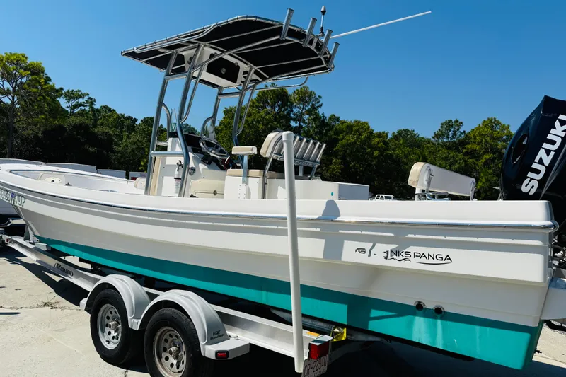 Slide: The Image of 2023 Banks Panga 23 Center Console boat on trailer, featuring Suzuki engine, outdoors. - 19