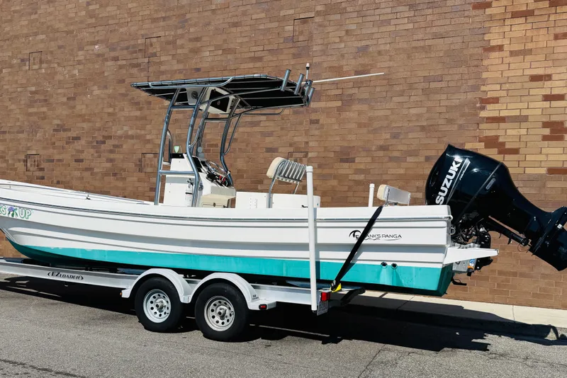 Slide: The Image of 2023 Banks Panga 23 Center Console boat on trailer, brick wall background. - 2