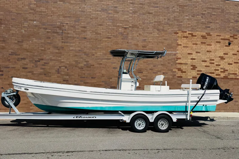 Slide: The Image of 2023 Banks Panga 26 Center Console boat on trailer, parked against brick wall. - 22