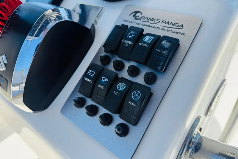 Slide: The Image of Control panel of 2023 Banks Panga 23 Center Console boat with labeled switches. - 5