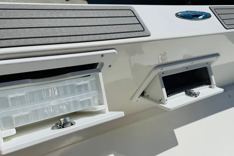 Slide: The Image of 2023 Banks Panga 23 Center Console storage compartments with tackle box and netting. - 8