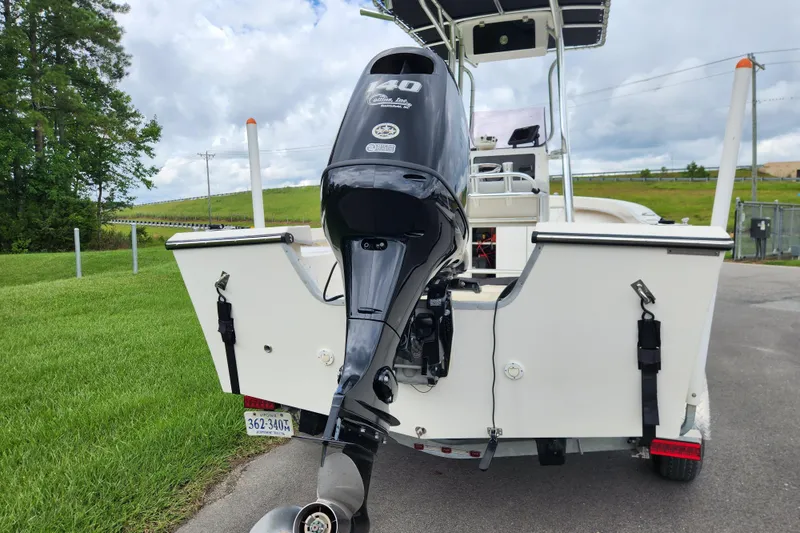 Slide: The Image of 2023 May-Craft 1900CC boat with powerful outboard motor, parked on a grassy area. - 3