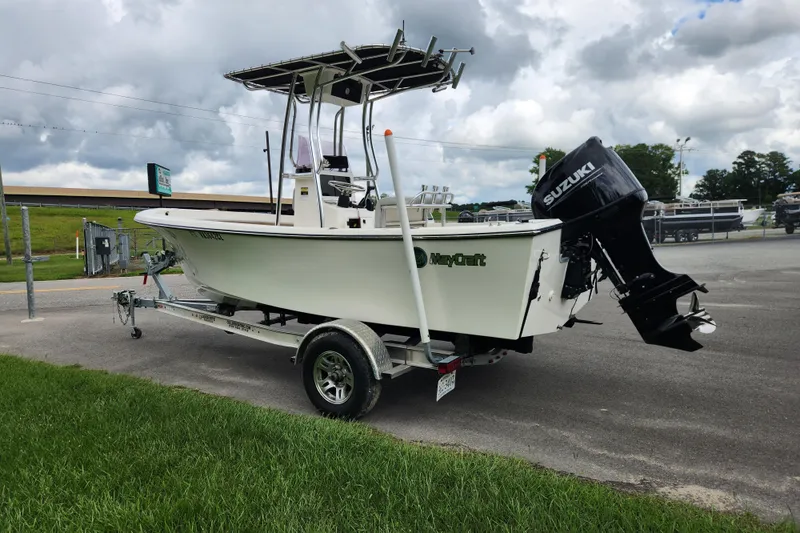 Slide: The Image of 2023 May-Craft 1900CC boat with Suzuki outboard motor on trailer, parked outdoors. - 4