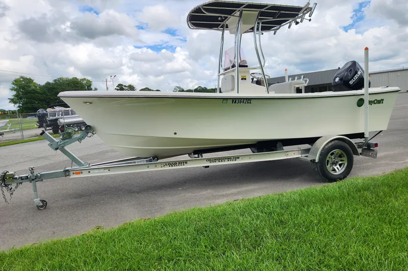 Slide: The Image of 2023 May-Craft 1900CC boat on trailer, parked outdoors under cloudy sky. - 6