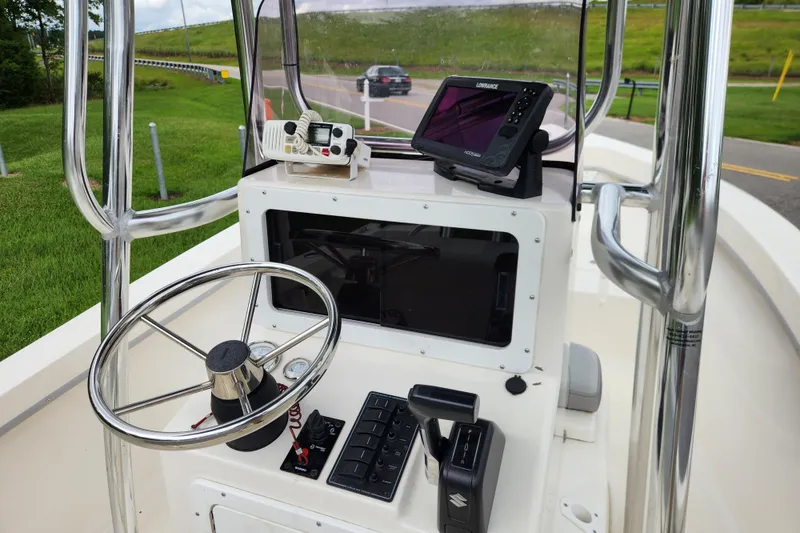 Slide: The Image of 2023 May-Craft 1900CC boat console with steering wheel and navigation equipment. - 9