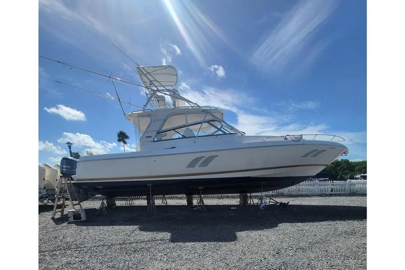Slide: The Image of 2010 Intrepid 475 Sport Yacht on dry dock under a clear blue sky. - 2