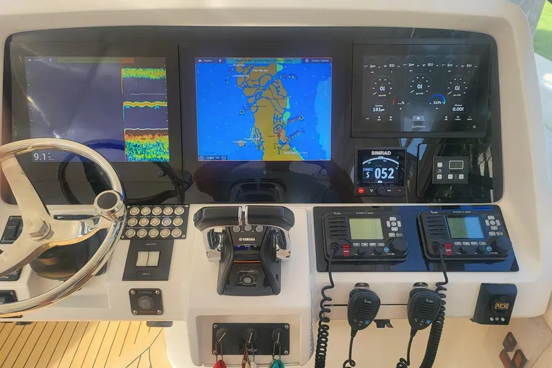 Slide: The Image of Control panel of a 2010 Intrepid 475 Sport Yacht with navigation and communication systems. - 4