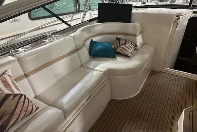 Slide: The Image of Luxurious seating area on 2010 Intrepid 475 Sport Yacht with cushions and wooden flooring. - 6