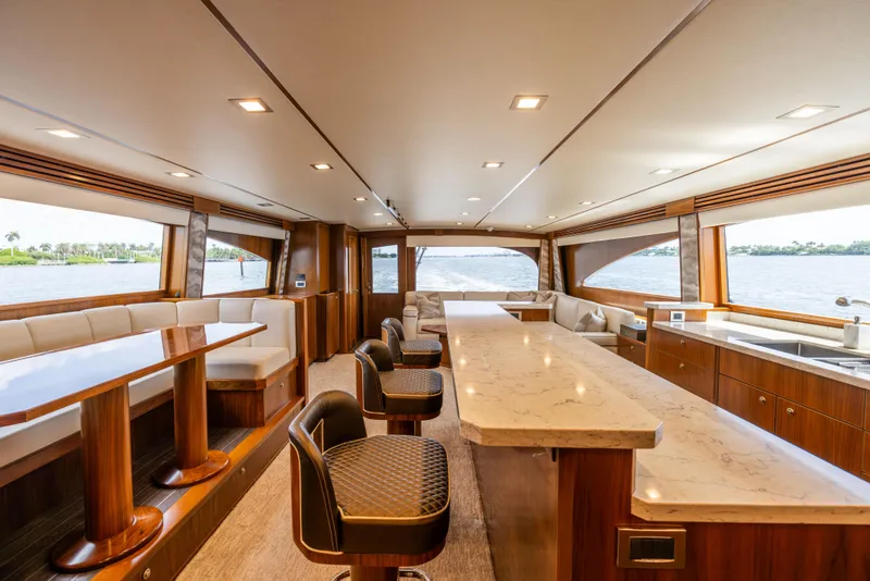 Slide: The Image of Luxurious interior of 2020 Viking 80 Convertible yacht with elegant seating and panoramic windows. - 11