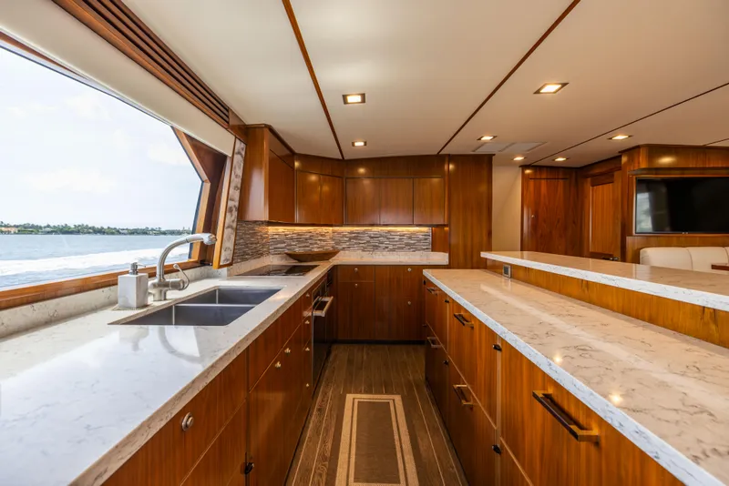 Slide: The Image of Luxurious kitchen interior of 2020 Viking 80 Convertible yacht with modern wood cabinetry. - 12