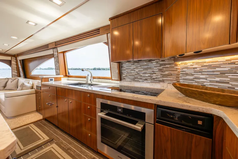 Slide: The Image of Luxurious kitchen interior of 2020 Viking 80 Convertible yacht with modern appliances and wood cabinetry. - 15
