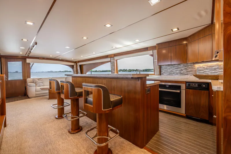 Slide: The Image of Luxurious interior of 2020 Viking 80 Convertible yacht with modern kitchen and seating area. - 16